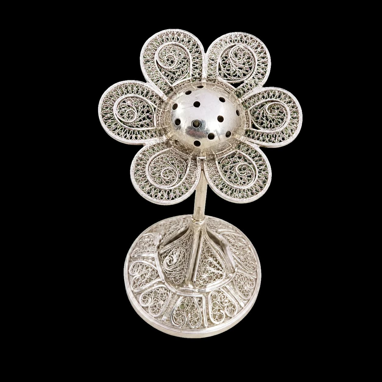 Silver filigree perfume bottle topped with a flower-shaped stopper