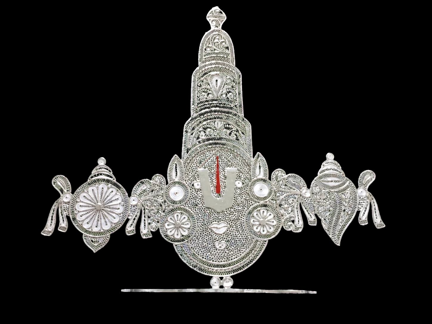 Silver filigree temple ornament beneath a decorated canopy