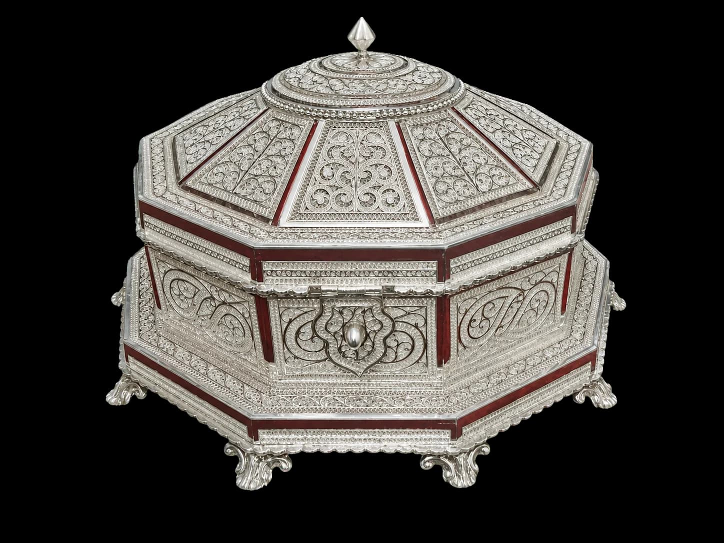 Octagonal silver filigree jewellery chest with a domed lid and deep red panel accents
