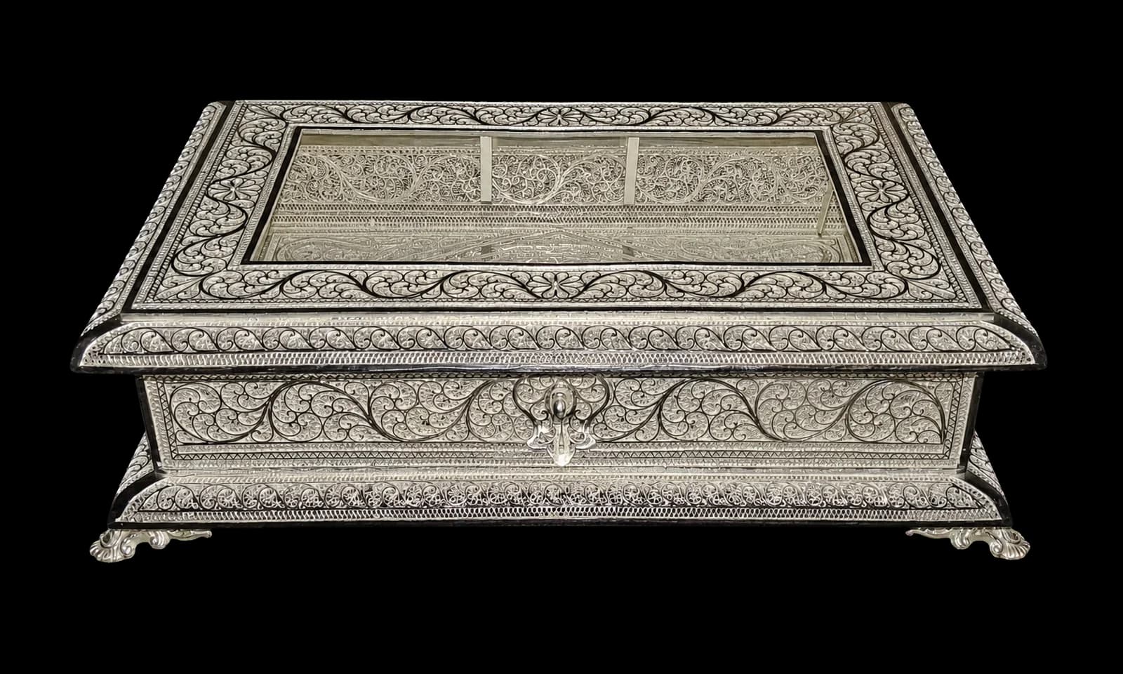 Broad silver jewellery chest with a domed lid and intricate wire panels